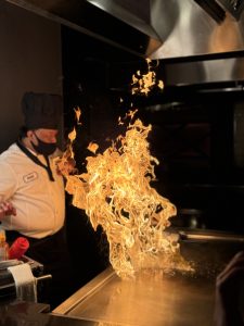 What is Teppanyaki? An ancient Japanese culinary tradition where food is grilled on a flat iron grill top in front of a table of diners. 